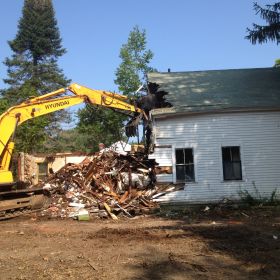 Taking down the existing structure begins.