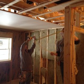 Installing ceiling in bedroom.