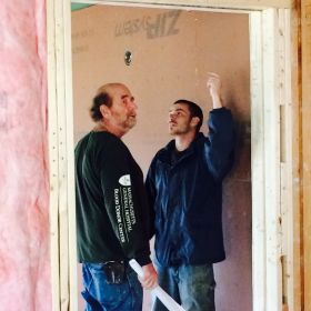 Construction Manager John Smith discusses details of the safe room with a contractor.