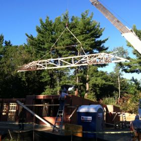 Crane moves trusses into place