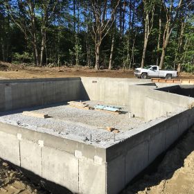 Foundation walls finished and back-filled.