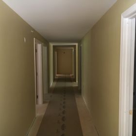 Drywall and trim complete in main hallway.