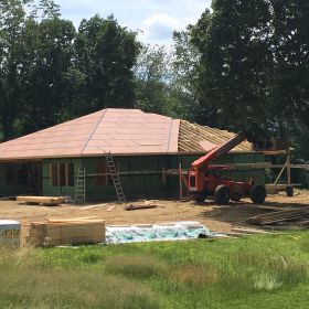 Roof sheathing going on.