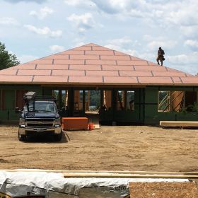 Roof sheathing going on another view.