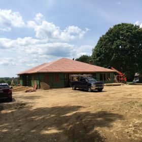 Roof sheathing nearly complete.