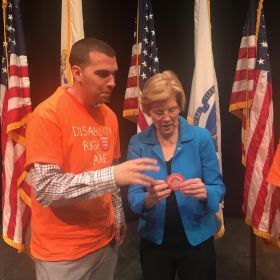 Shawn giving our pin to Senator Warren.