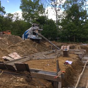 Foundation footings being poured.