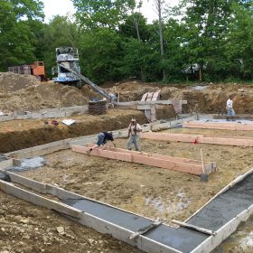 Foundation footings being poured.