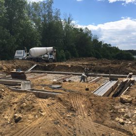 Foundation footings being poured.