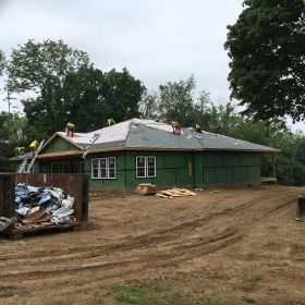 Right front view of roof shingles going on.