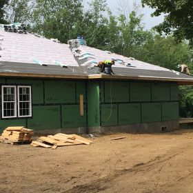 Right side view of roof shingles being installed.