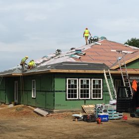 Left front view of roof shingles going on.