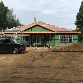 Front center view of roof shingles going on.